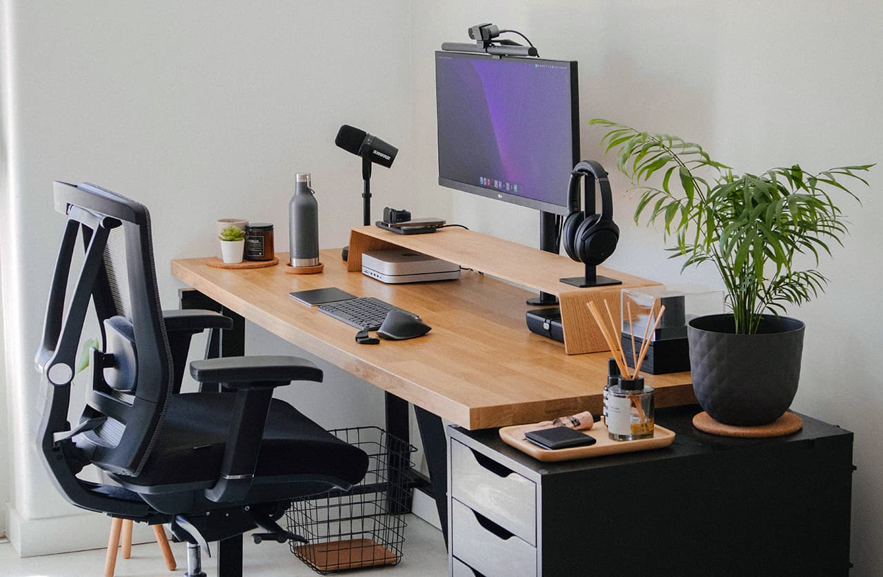 Modern desk with computer, chair, and ergonomic workspace accessories