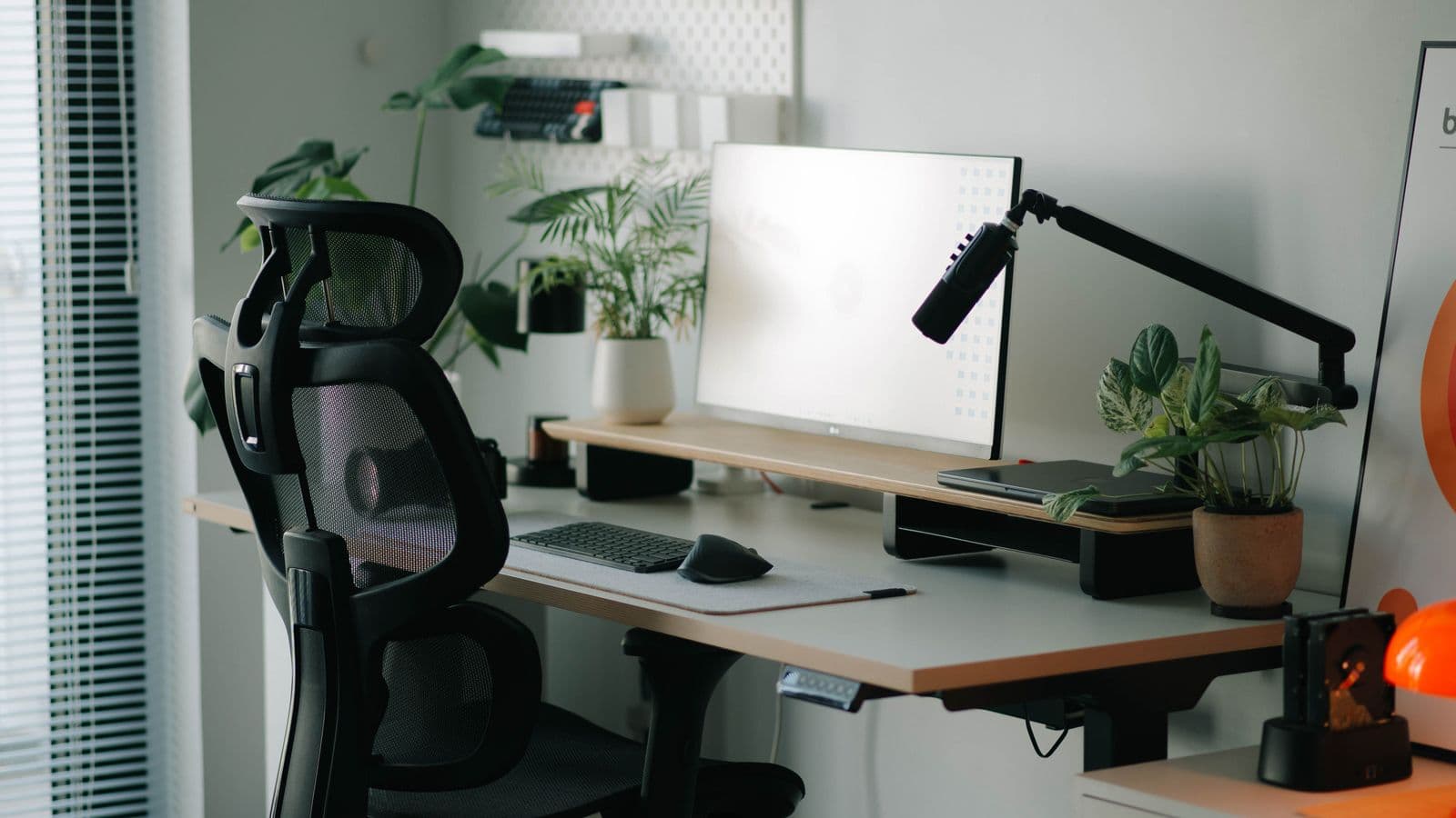 Modern desk with computer, chair, and ergonomic workspace accessories